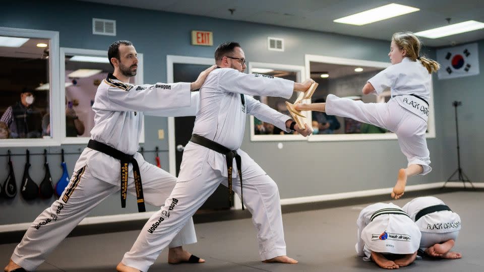 Aubrey Sauvie, who was born with no hands and a partially amputated left foot, breaks boards for her second-degree black belt in taekwondo. - Jennifer Sauvie