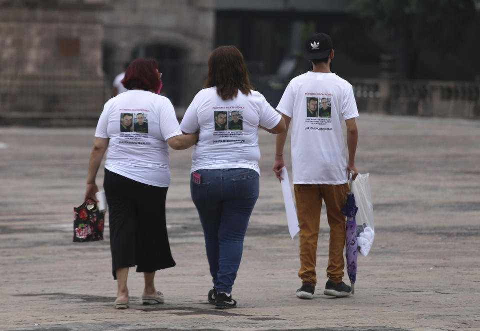 Family members wear T-shirts with photos of disappeared Jorge Arevelo and Ricardo Valdes, during a protest in Monterrey, Nuevo Leon state, Mexico, Thursday, June 24, 2021. As many as 50 people in Mexico are missing after they set off on simple highway trips between the industrial hub of Monterrey and the border city of Nuevo Laredo; relatives say they simply disappeared on the heavily traveled road, which has been dubbed ‘the highway of death,’ never to be seen again. (AP Photo/Roberto Martinez)