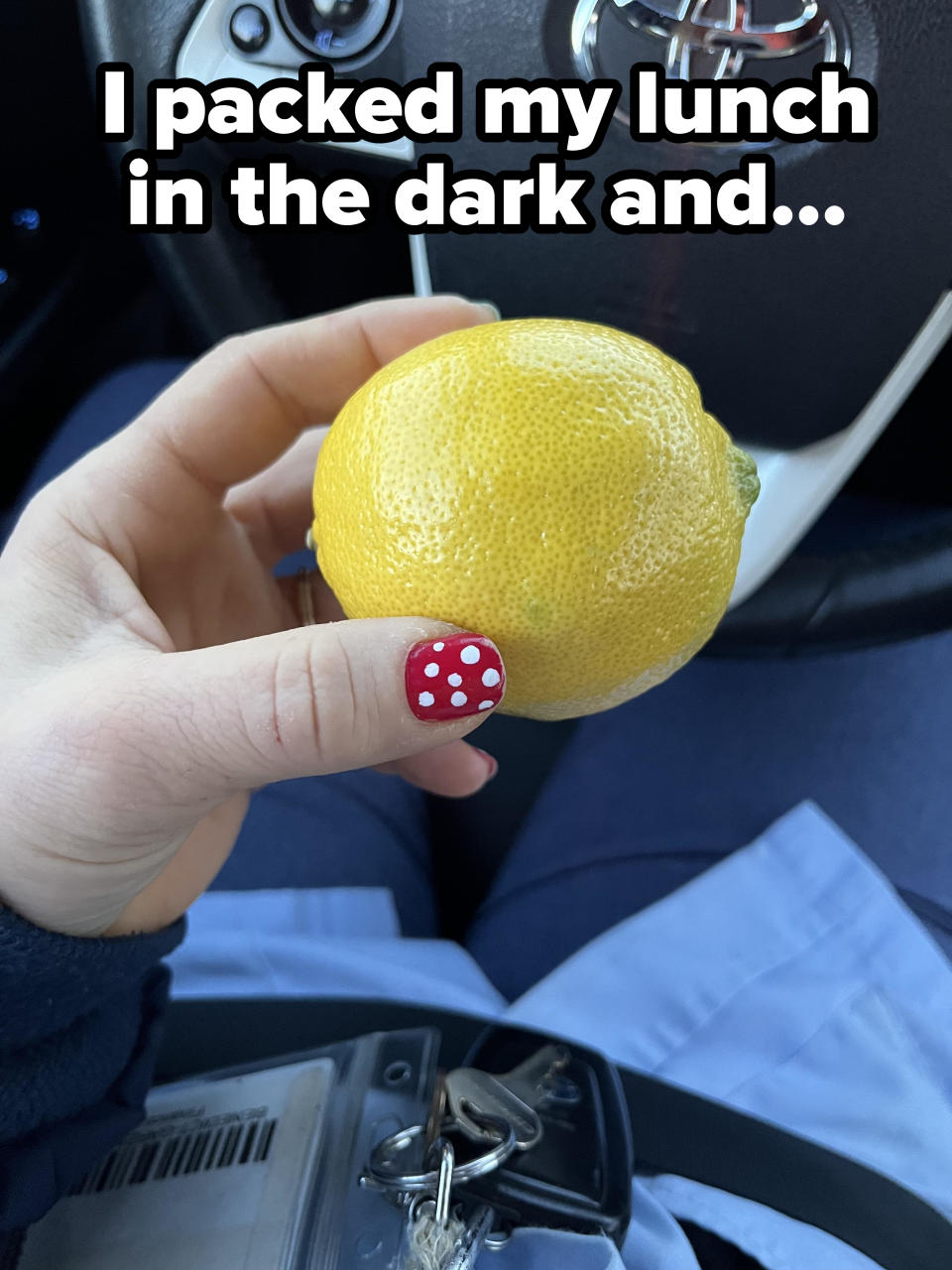 A person holding a lemon with caption "I packed my lunch in the dark"