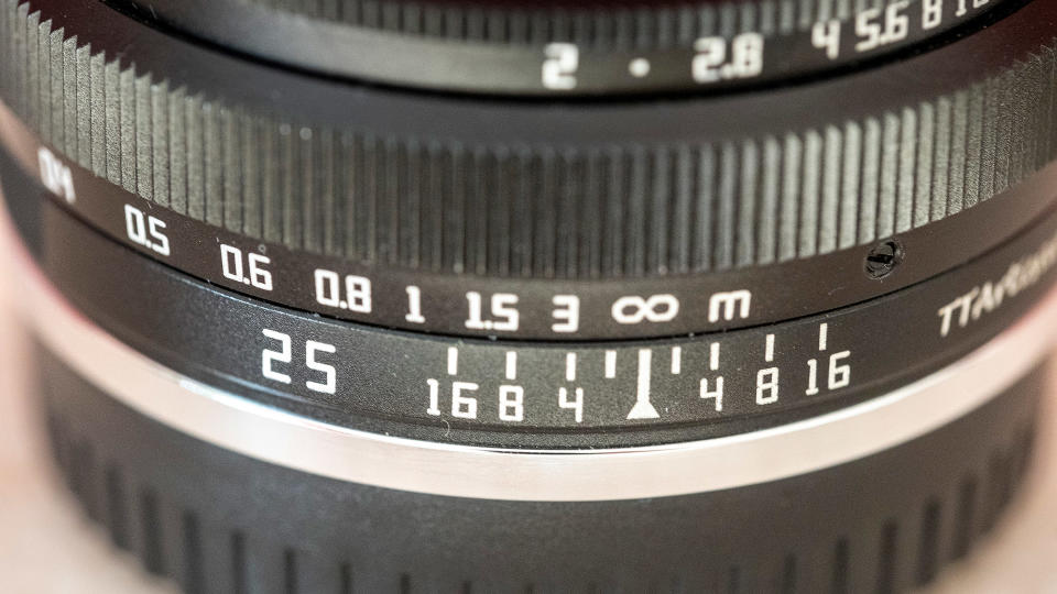 Close up of the focus and aperture markings on the TTArtisan 25mm f/2 lens