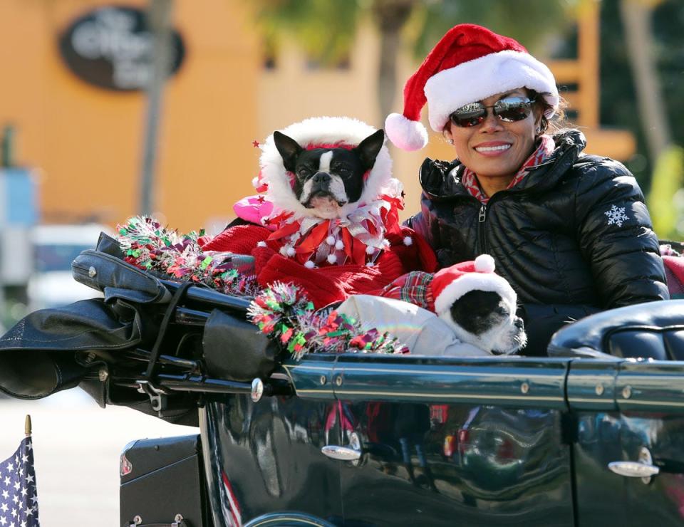 A woman and her dog show their festive spirit during a past Christmas Parade in Destin. The city's 38th annual Christmas Parade is scheduled for Saturday, Dec. 10 at 10 a.m.
