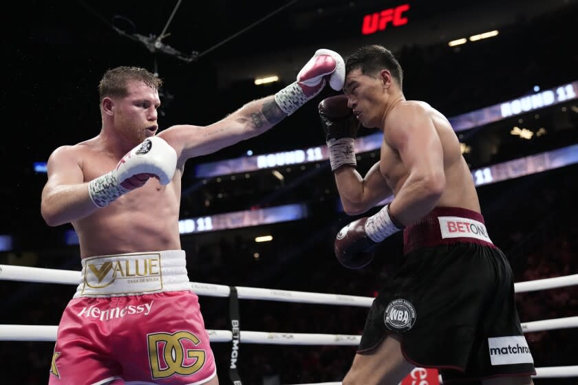 Canelo Alvarez, left, of Mexico, throws a punch against Dmitry Bivol.