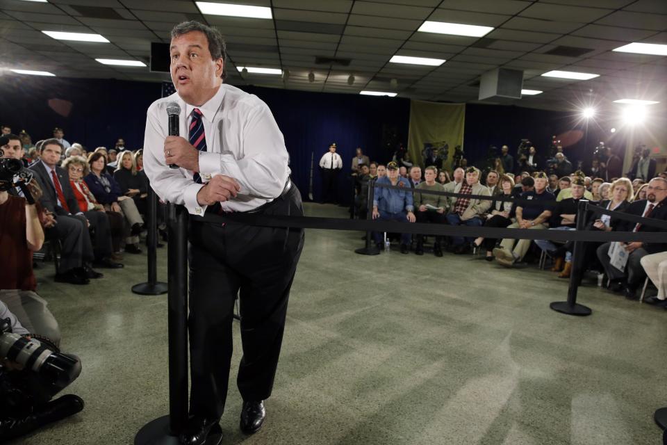 Gov. Chris Christie rests on a post as he addresses a large gathering Thursday, Feb. 20, 2014, in Middletown, N.J., during a town hall meeting. Christie returned to Republican-controlled Monmouth County on Thursday for his first town hall since private emails revealed a political payback scandal in which his associates ordered traffic lanes closed, causing lengthy backups. But the scandal didn't come up. Instead, the 51-year-old Republican heard from residents who have not returned to their homes since the 2012 storm. (AP Photo/Mel Evans)