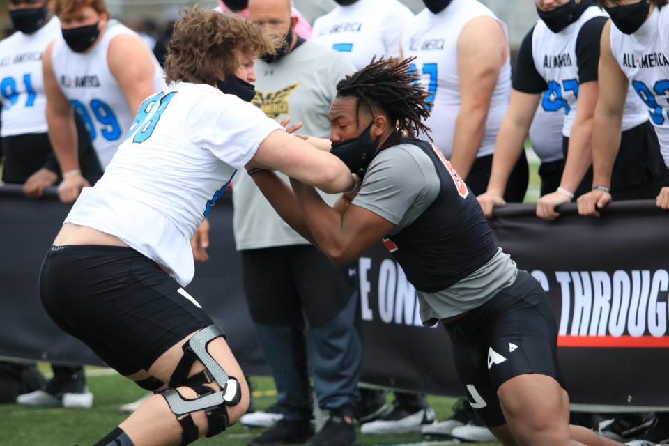 Walton High School offensive tackle Cason Henry battles with Florida State commit Gabriel Harris at the Under Armour Camp.