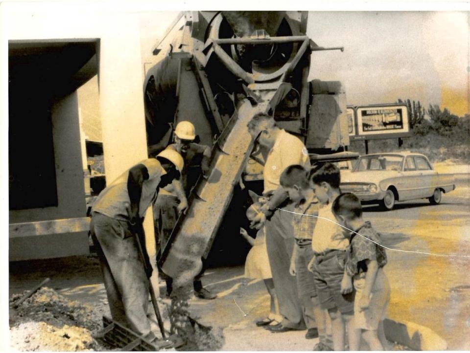 In this family photo from the early 1960s, Sunset Corners, founded in December 1954 by Bernard Rudnick (top right) oversees the first upgrade of his store. He’s standing with his grandchildren as crews pour cement. Wendy Bittel Gelbard, Larry Solomon, Michael Bittel and Stephen Bittel.