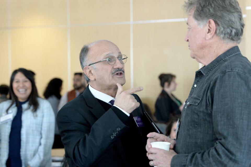 Jamshid Damooei, left, a professor of economics at California Lutheran University speaks with Jack Edelstein, board member of Ventura County Community Foundation, at a conference on undocumented immigrants at Lundring Events Center on the CLU Campus on Thursday.