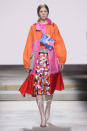 <p><i>Model wears a bright orange, pink, and red raincoat. (Photo: ImaxTree) </i></p>