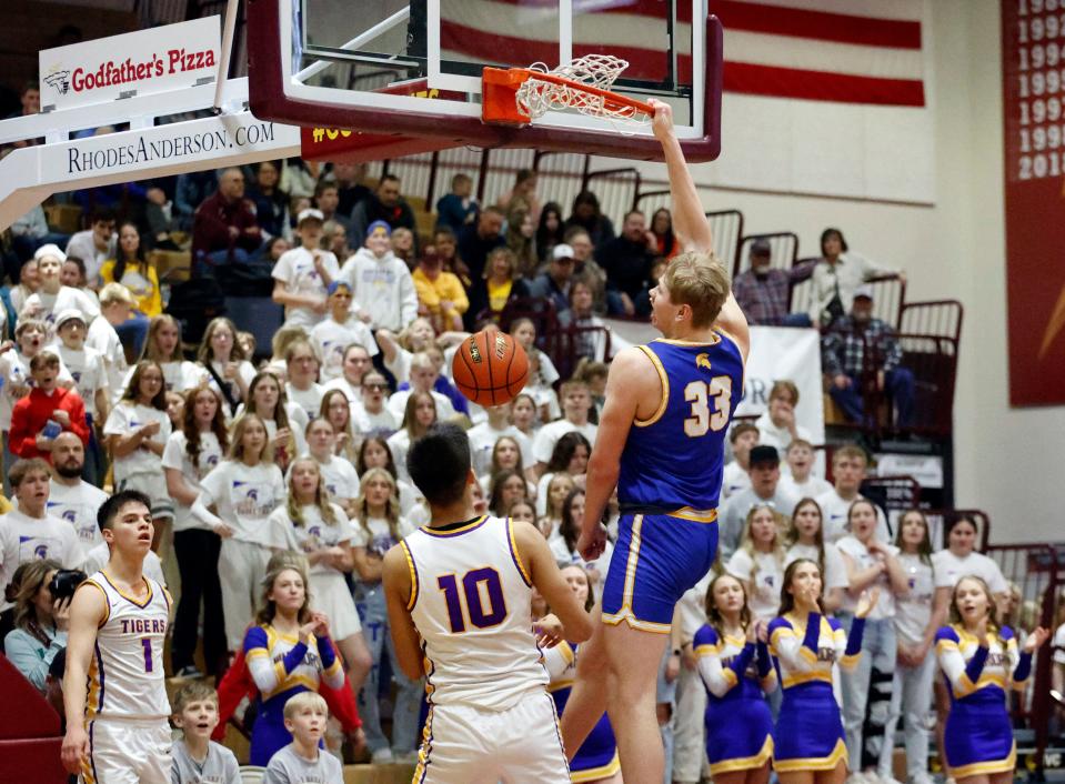 Castlewood’s Bryon Laue (33) follows through on a dunk as White River’s Nicolas Marshall (1) and Evastine Wright (10) look on during the third-place game of the state Class B boys basketball touranment on Saturday, March 16, 2024 in Wachs Arena at Aberdeen.