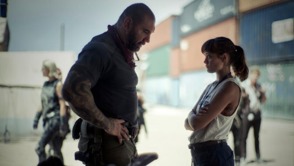 Dave Bautista stands over Ella Purnell is a scene from Army of the Dead.