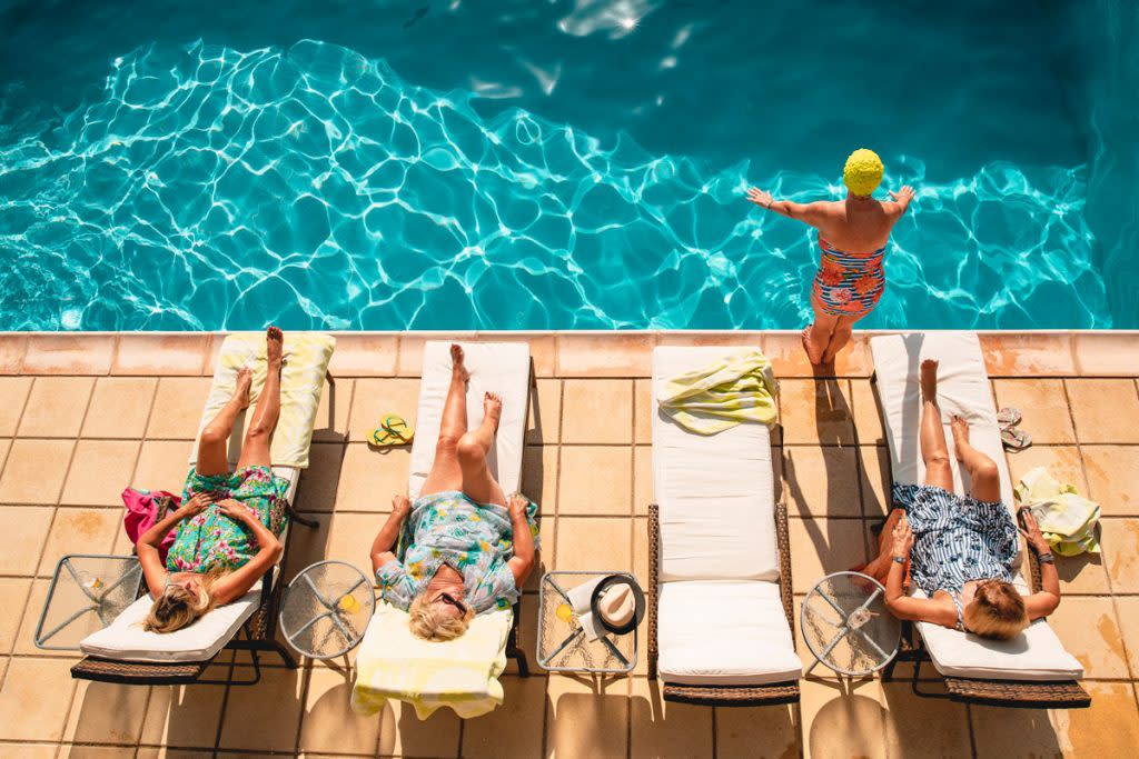 Senior citizens lay by the pool. This is meant to represent what age is best to start taking out social security.