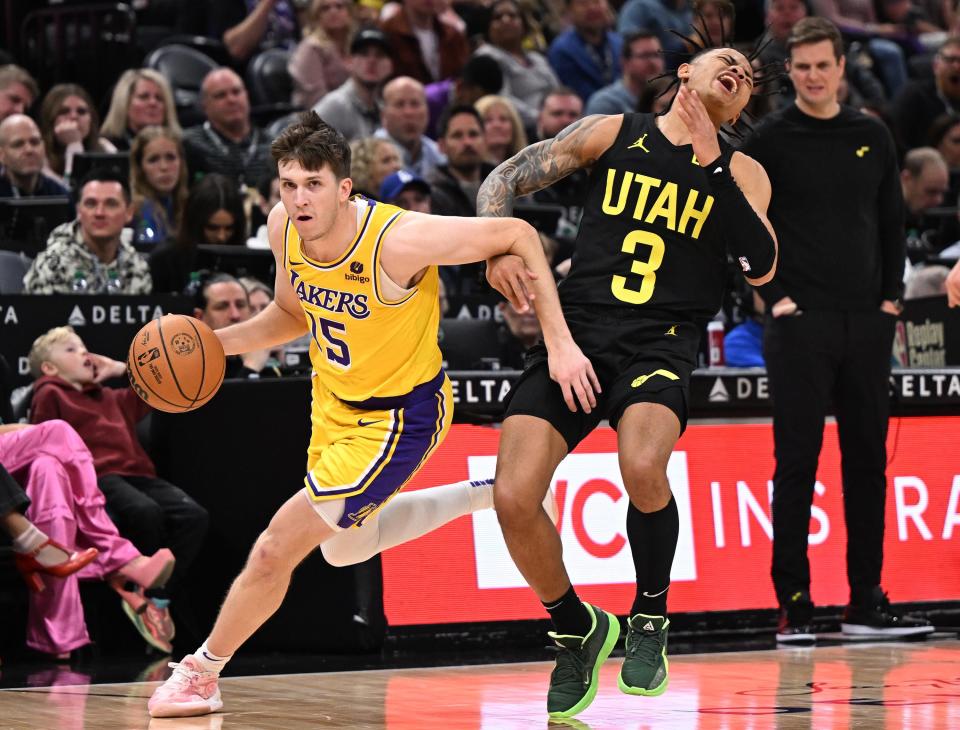 Utah Jazz guard Keyonte George (3) reacts as Los Angeles Lakers guard Austin Reaves (15) drives around him as the Utah Jazz and the Los Angeles Lakers play at the Delta Center in Salt Lake City on 2/14/24. LA won 138-122. | Scott G Winterton, Deseret News