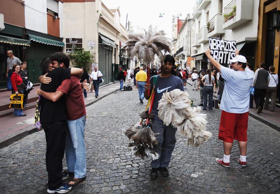 Street artists offer hugs free of charge in Buenos Aires, Argentina.