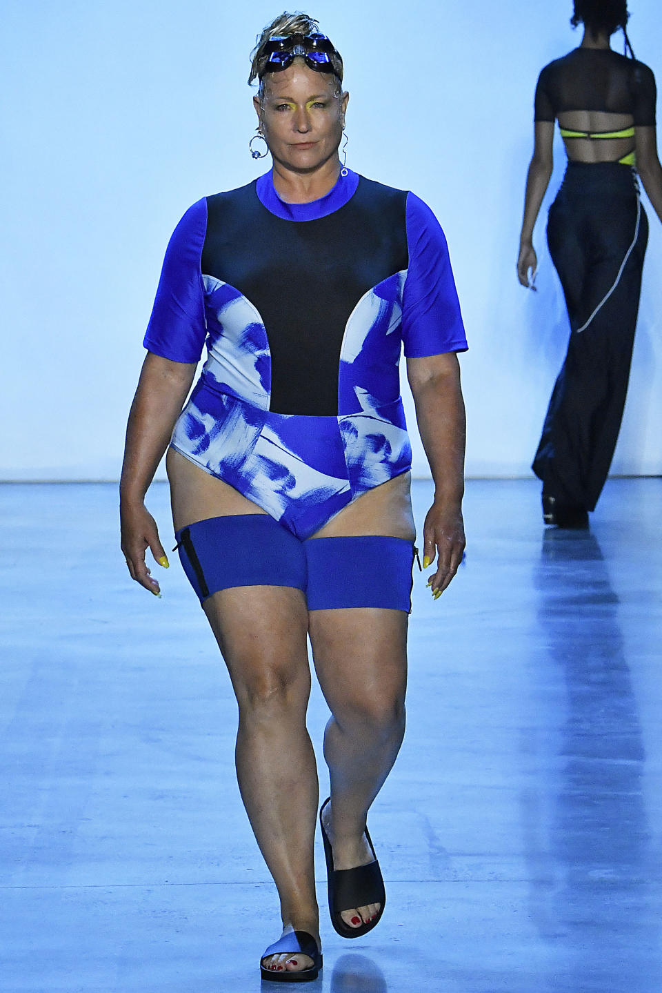 <p>A curvy model wears a tie-dye swimsuit and thigh bands by Bandelettes at Chromat’s show during New York Fashion Week. (Photo: Getty Images) </p>