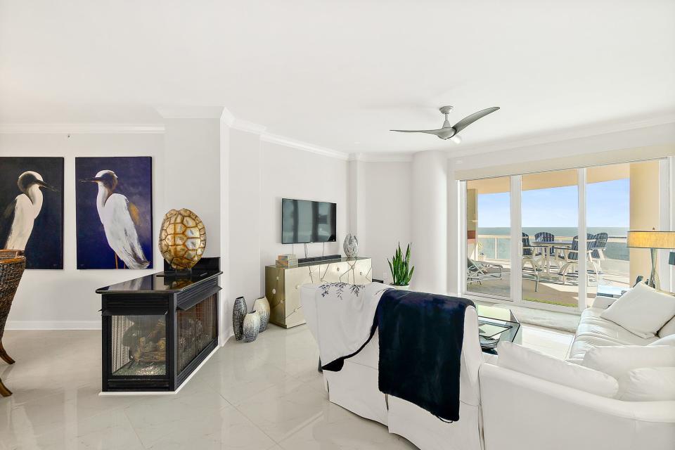 This condominium showcases 24-inch-by-24-inch Calacatta gold porcelain high-gloss floor tile throughout