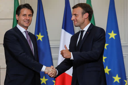 French President Emmanuel Macron and Italian Prime Minister Giuseppe Conte shake hands at the end of a joint news conference at the Elysee Palace in Paris, France, June 15, 2018. Ludovic Marin/Pool via Reuters