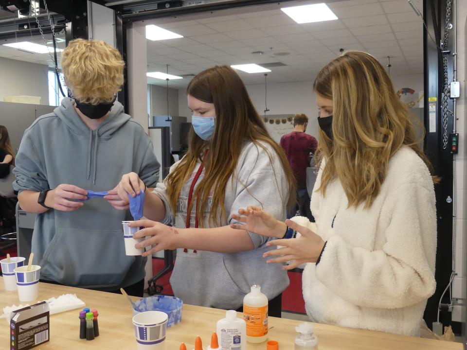 Patrick Campbell, McKenzie Parks and Kinsey Rose, eighth graders at Edgewood Junior High School, work in the design lab at school on Nov. 18. Slime is one of the items they will put inside a sensory bag for students at Edgewood Primary School.