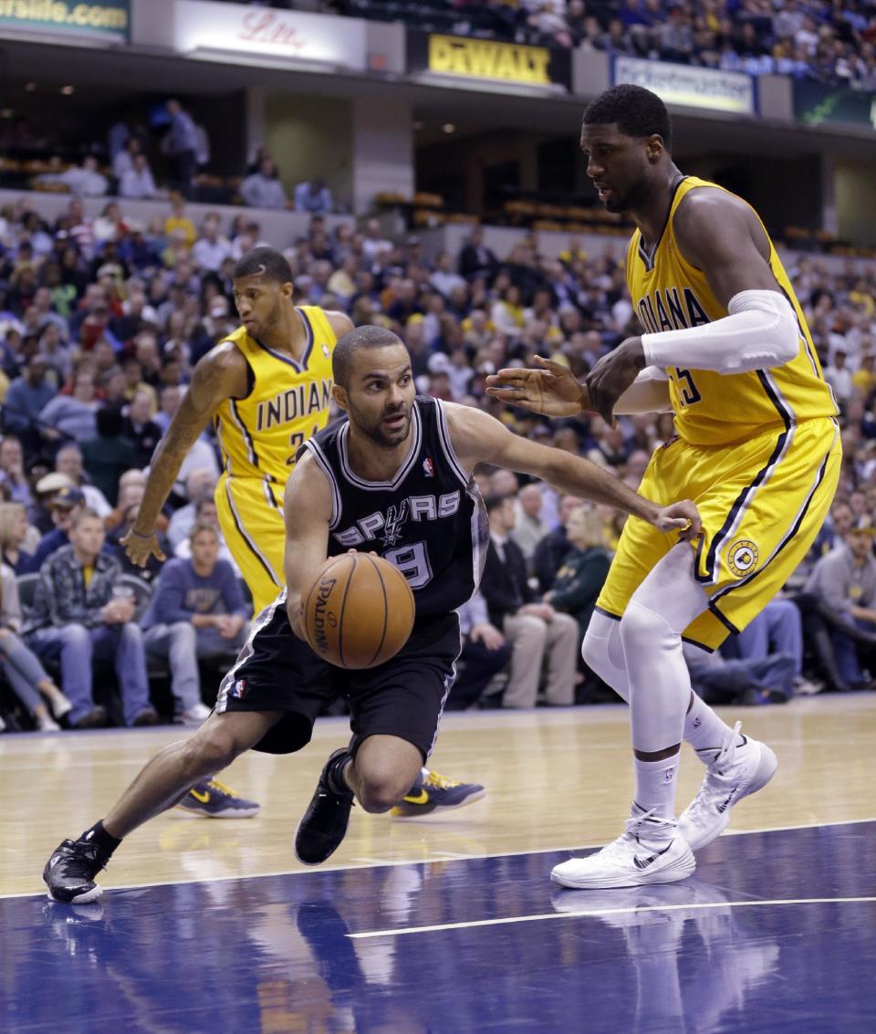 San Antonio Spurs guard Tony Parker, left, drives around Indiana Pacers center Roy Hibbert in the second half of an NBA basketball game in Indianapolis, Monday, March 31, 2014. The Spurs defeated the Pacers 103-77. (AP Photo/Michael Conroy)