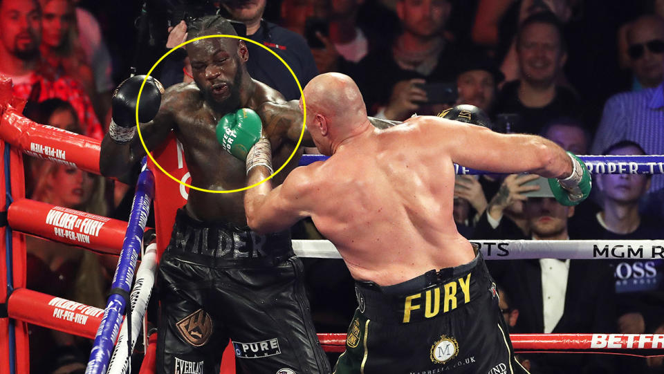 Tyson Fury punches Deontay Wilder in the chest.