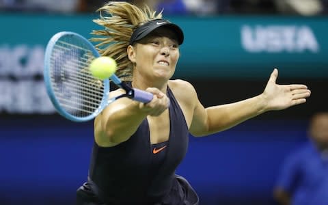 Maria Sharapova of Russia hits a return to Serena Williams of the US  - Credit: Rex