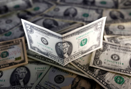 Dollar holding steady near 2-week highs