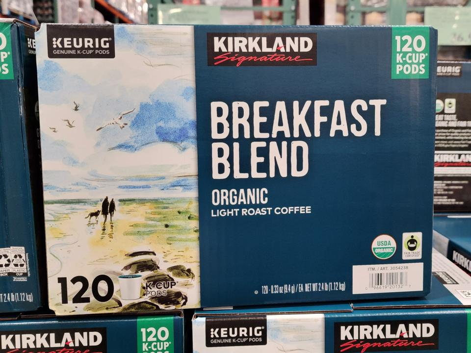 A blue box of Kirkland Signature's breakfast coffee blend on a stack of other boxes at Costco