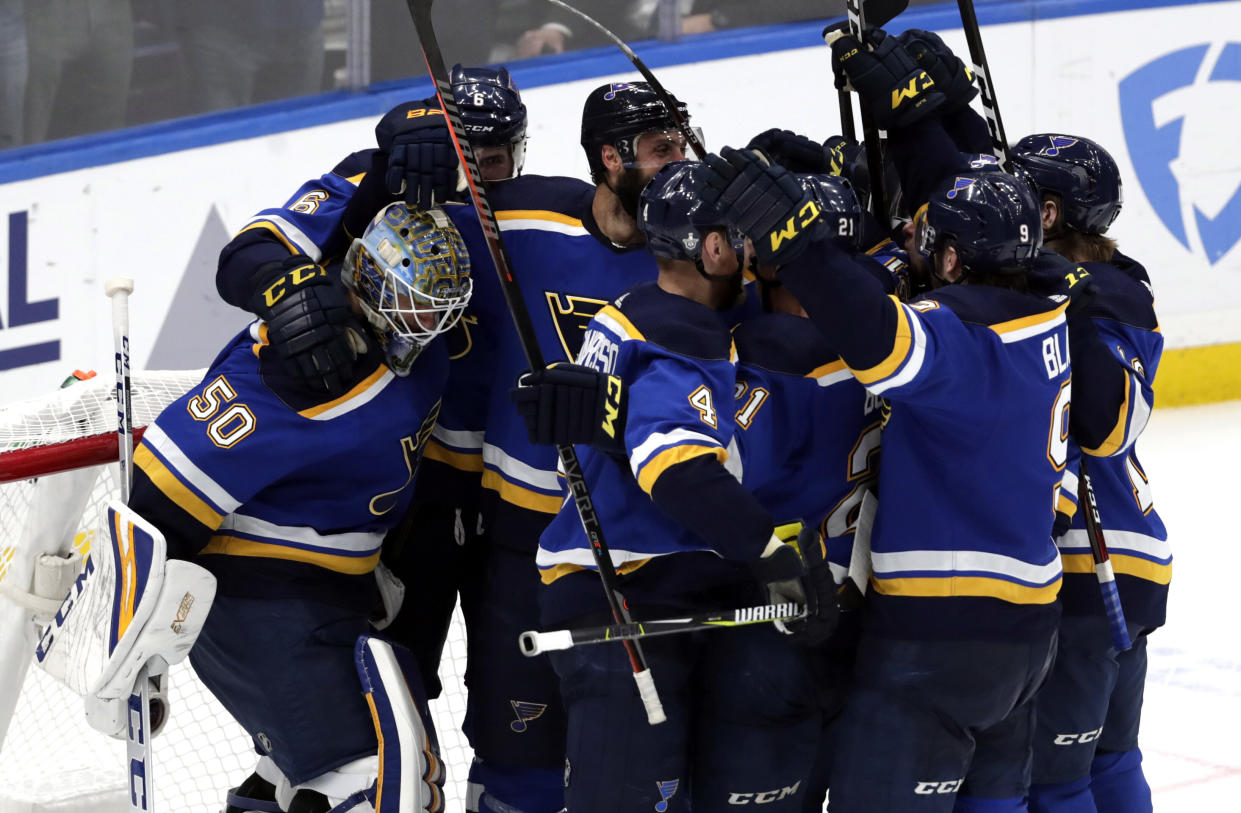 Members of the St. Louis Blues celebrate after defeating the San Jose Sharks 5-1 in Game 6 of the NHL hockey Stanley Cup Western Conference final series Tuesday, May 21, 2019, in St. Louis. (AP Photo/Tom Gannam)