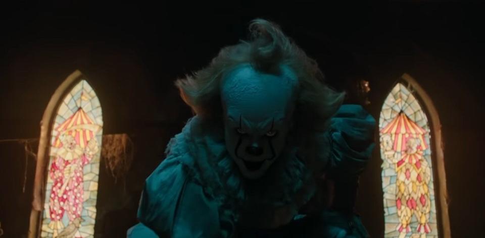 Pennywise crouching in the clown room in "It"