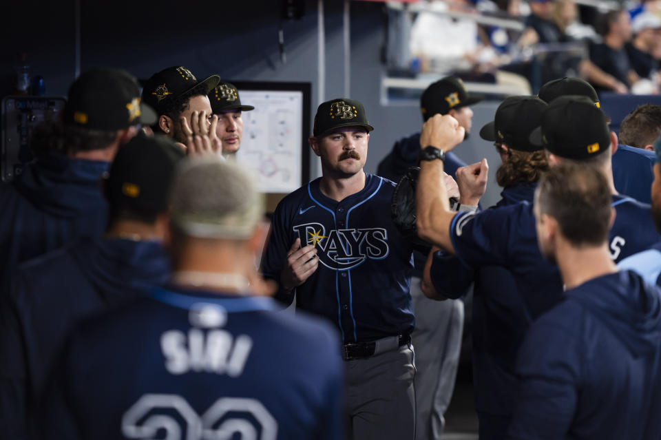 Tampa Bay Rays pitcher Tyler Alexander is congratulated after he left in the eighth inning of the team's baseball game against the Toronto Blue Jays on Friday, May 17, 2024, in Toronto. (Christopher Katsarov/The Canadian Press via AP)