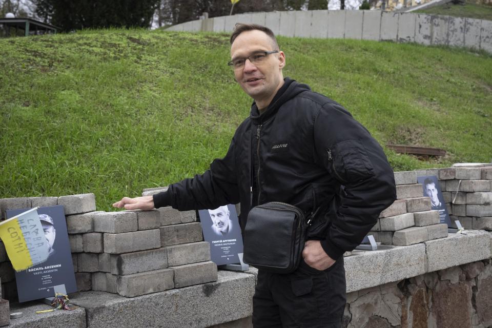 FILE - Dmytro Riznychenko, who took part in the uprising that eventually ousted Ukraine's Moscow-friendly president, visits a memorial to the victims in Kyiv, Ukraine, on Thursday, Nov. 16, 2023. On Nov. 21, Ukraine marks the 10th anniversary of the protests, which lasted for months and led to the deaths of over 100 people. (AP Photo/Efrem Lukatsky, File)