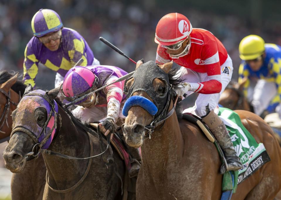 Jockey Ramon Vazquez guides Practical Move to a win over Mandarin Hero, with Kazushi Kimura aboard, in the Santa Anita Derby.