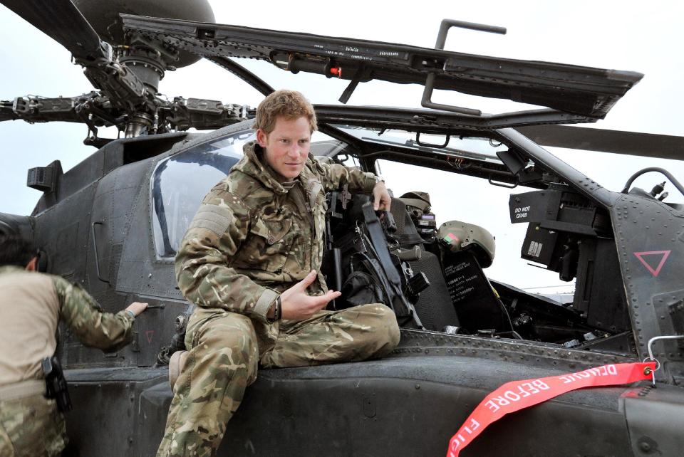 FILE - In this file photo taken Dec. 12, 2012, made available Monday, Jan. 21, 2013, Britain's Prince Harry or just plain Captain Wales as he is known in the British Army, talks to a TV crew after making his early morning pre-flight checks on the flight-line, from Camp Bastion southern Afghanistan. Palace officials say that Prince Harry is ending his role as a helicopter pilot and taking up a new job with the army in London. Kensington Palace said Harry will now be organizing "major commemorative events" involving the army. (AP Photo/ John Stillwell, Pool, File)