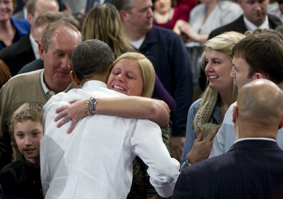 A woman hugs President Barack Obama after he spoke on energy policy and the economy at Nashua Community College, in Nashua, New Hampshire, March 1, 2012.