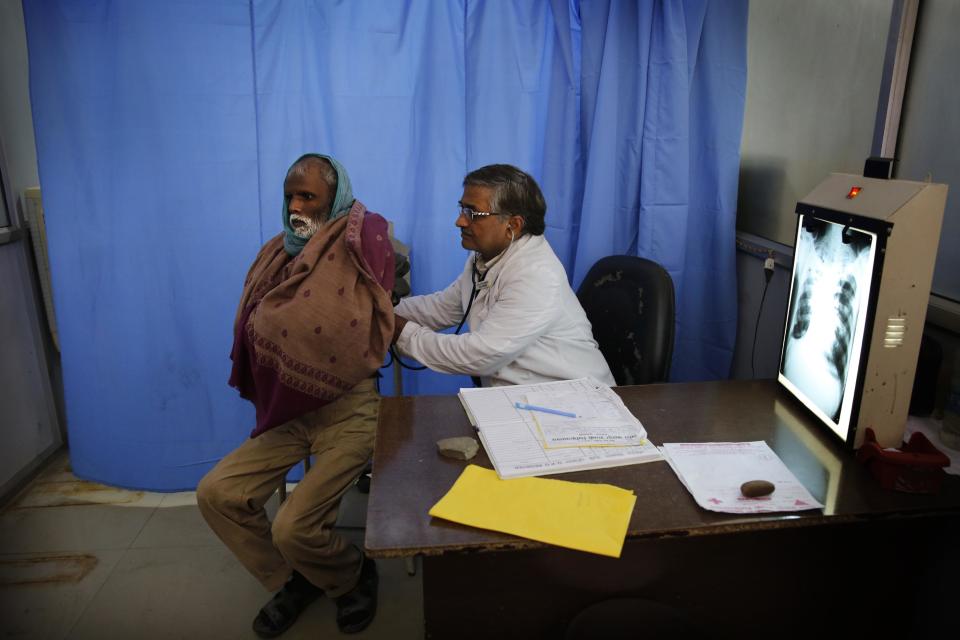 In this Monday, Feb. 3, 2014 photo, senior chest physician Dr. A.K. Upadhaya, right, checks patient Shyam Lal, suspected to have tuberculosis, at Lal Bahadur Shastri Government Hospital in Ram Nagar, Varanasi, India. India has the highest incidence of TB in the world, according to the World Health Organization's Global Tuberculosis Report 2013, with as many as 2.4 million cases. India saw the greatest increase in multidrug-resistant TB between 2011 and 2012. The disease kills about 300,000 people every year in the country. (AP Photo/Rajesh Kumar Singh)