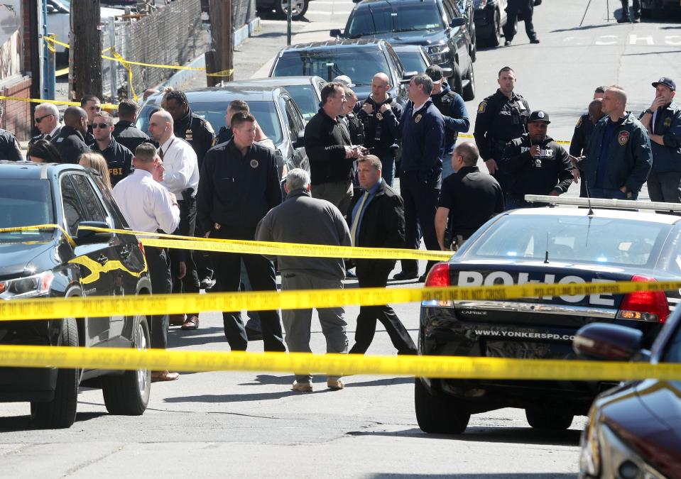 Several Yonkers police officers converge on the intersection of Elm Street and Linden Street in the Nodine Hill section of Yonkers, following a police involved shooting April 20, 2022. 