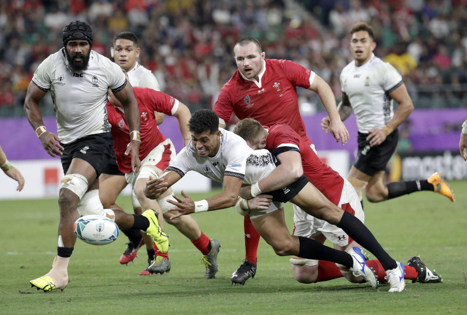 Fiji's Ben Volavola loses the ball in the tackle during the Rugby World Cup Pool D game at Oita Stadium between Wales and Fiji in Oita, Japan, Wednesday, Oct. 9, 2019. (AP Photo/Aaron Favila)