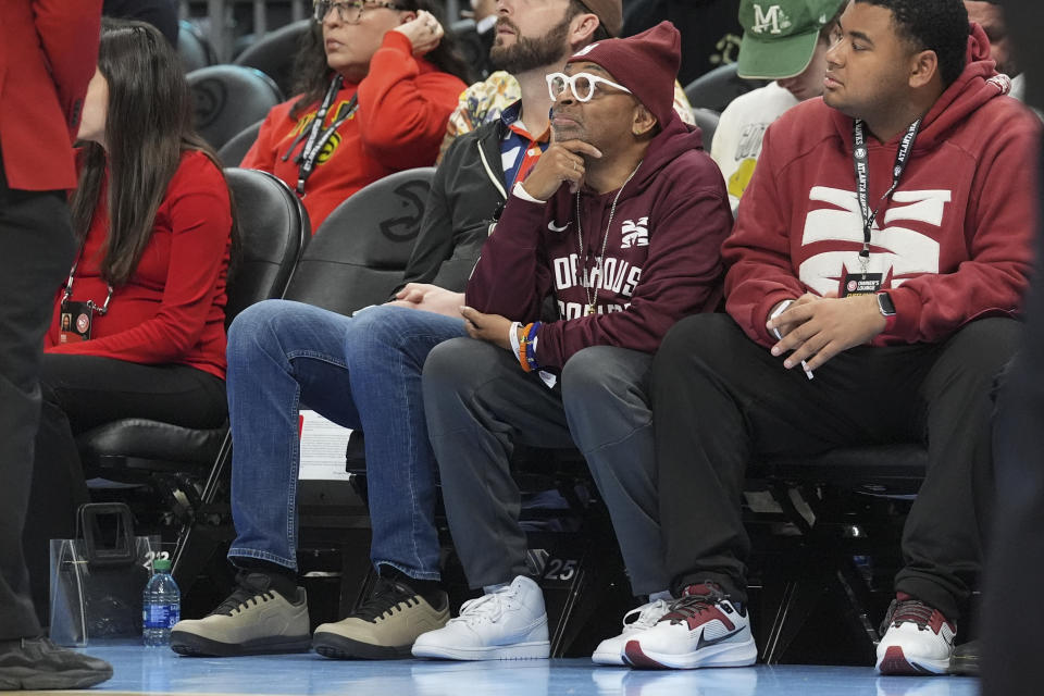 Movie director Spike Lee, second from right, sits courtside during the first half of an NBA basketball game between San Antonio Spurs and Atlanta Hawks Monday, Jan. 15, 2024, in Atlanta. (AP Photo/John Bazemore)