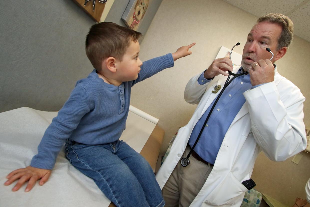 Dr. Brian Benfield gets ready to examine three-year-old Huxley Falls Tuesday morning, March 26, 2024, at the Atrium Health Levine Children's Shelby Children's Clinic.