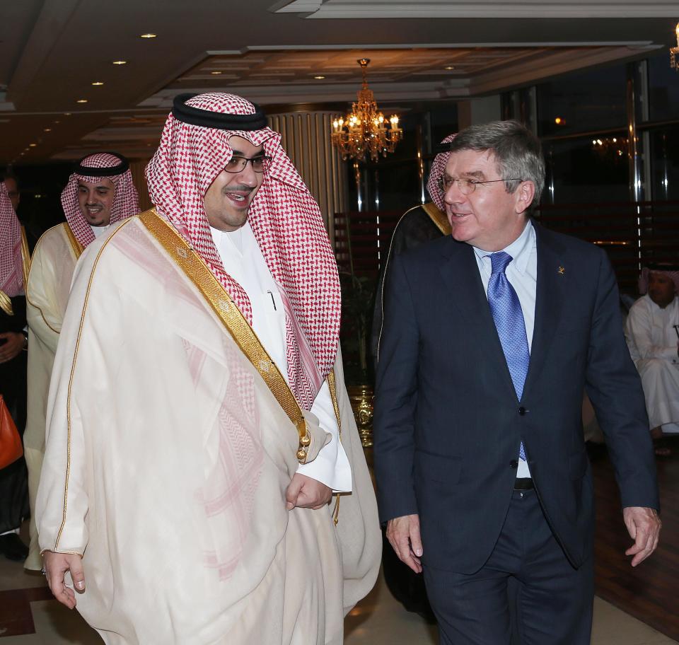 This image released by the Saudi Press Agency shows Prince Nawaf Faisal Fahd bin Abdul-Aziz, an International Olympic Committee member and president of the national Olympic committee, left, walking with IOC President Thomas Bach, right, in Riyadh, Saudi Arabia, Wednesday, April 2, 2014. IOC President Thomas Bach has discussed the issue of women’s participation in sports with Saudi Arabia’s Olympic chief. The IOC says Wednesday that Bach promised “full support” for the country’s sports development strategy through 2020. The plan includes “proposals to increase women's participation in the Olympic Games and in sport in general.” Saudi women are largely banned from participating in sports in the kingdom, although there are several football and basketball clubs that play in clandestine leagues. After prolonged negotiations with the IOC, Saudi Arabia sent women to the Olympics for the first time in 2012, with two female athletes competing at the London Games. (AP Photo/Saudi Press Agency)