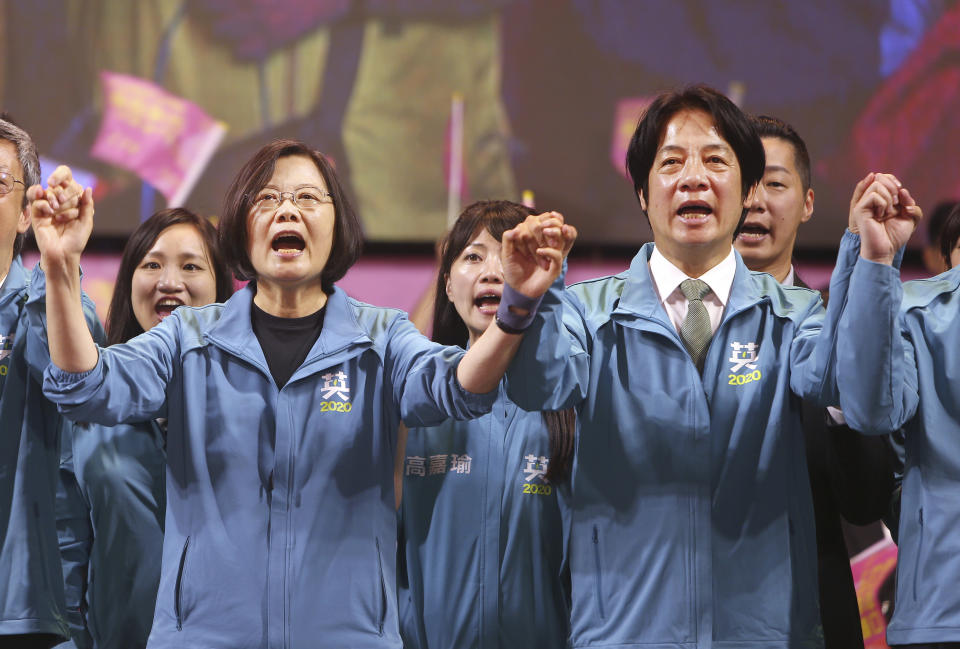 Taiwan President and Democratic Progressive Party presidential candidate Tsai Ing-wen, left, and her running mate William Lai cheer as Tsai launches her re-election campaign in Taipei, Taiwan, Sunday, Nov. 17, 2019. Taiwan will hold its presidential election on Jan. 11, 2020. (AP Photo/Chiang Ying-ying)