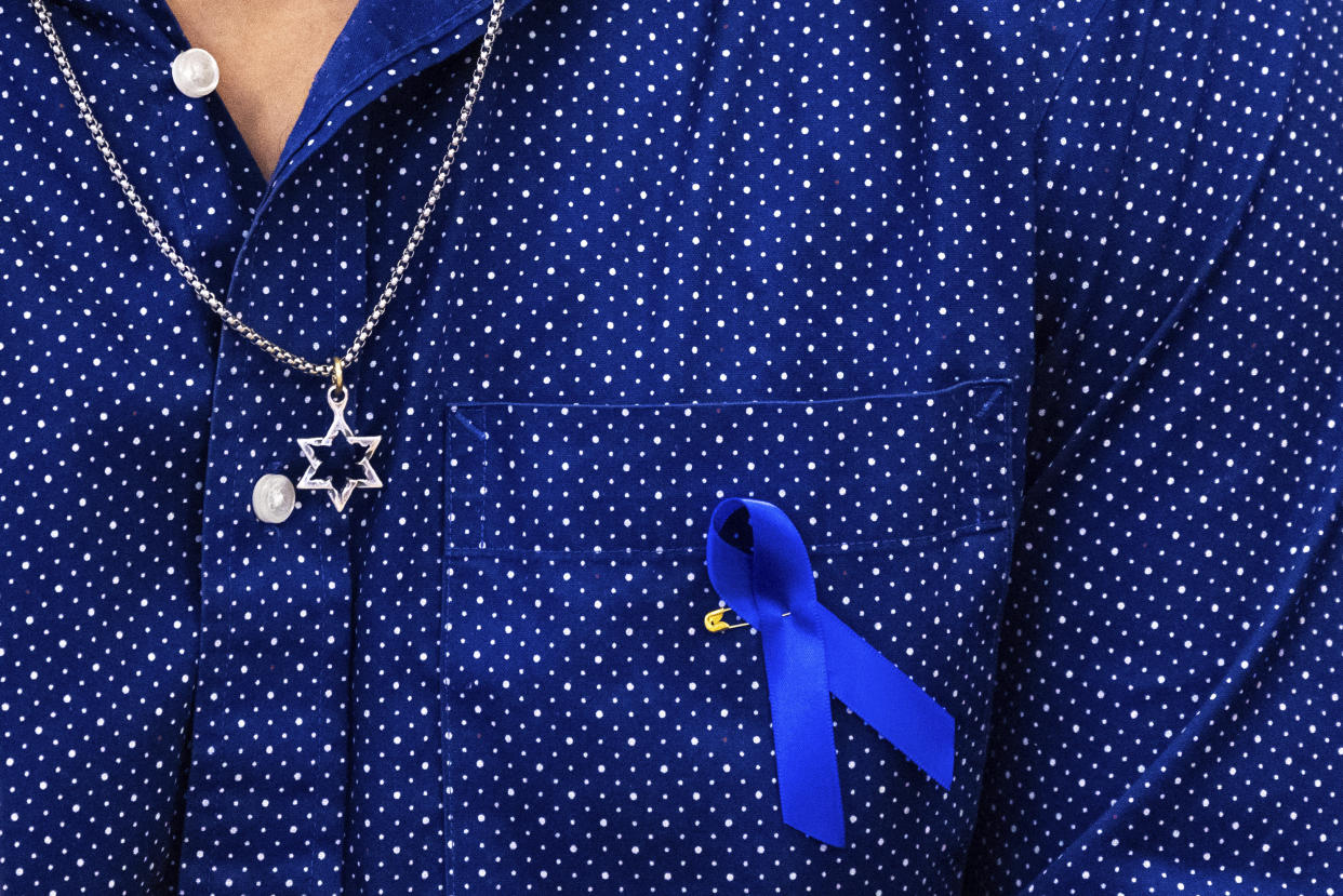 A Star of David necklace and a blue ribbon