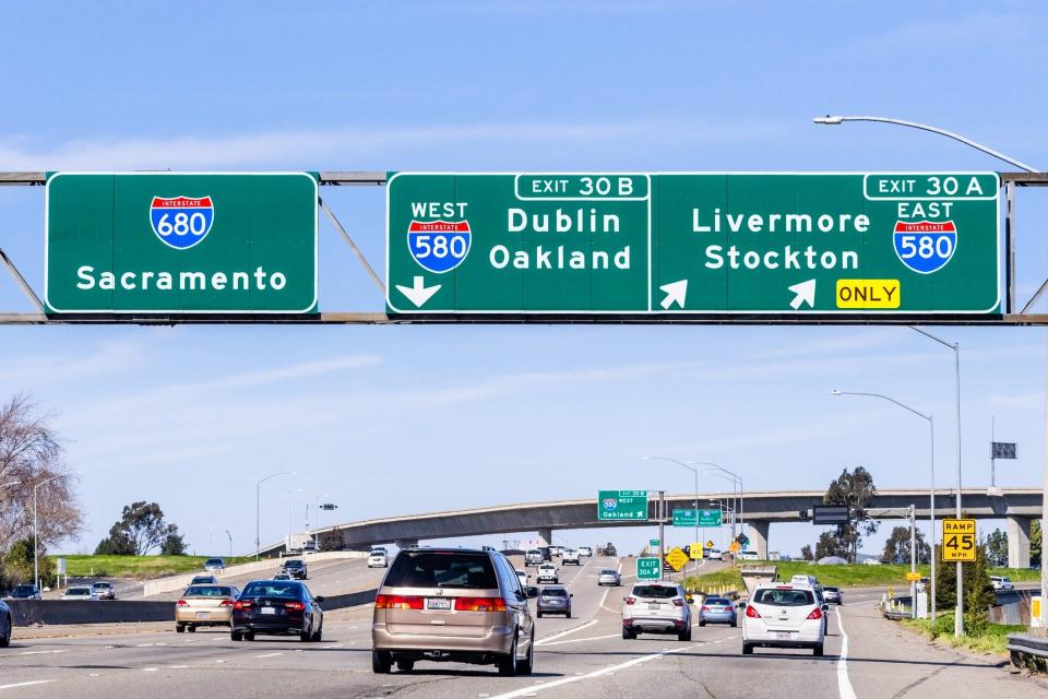 Feb 17, 2020 Pleasanton / CA / USA - Freeway interchange in East San Francisco Bay Area; Signs towards Sacramento, Oakland, Stockton and other destinations, guiding drivers in choosing the right lane.