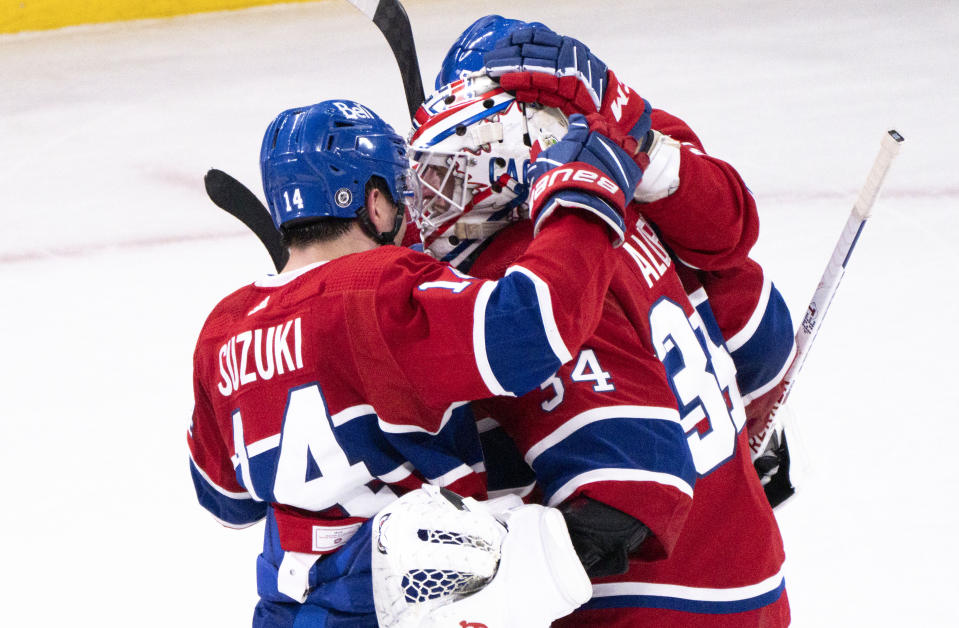 Montreal Canadiens goaltender Jake Allen is congratulated by teammate Nick Suzuki after stopping the Calgary Flames in the shootout to win 2-1 in an NHL hockey game in Montreal, Monday, Dec. 12, 2022. (Paul Chiasson/The Canadian Press via AP)