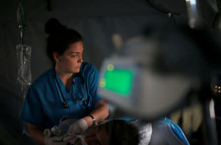 A foreign volunteer works at the emergency field hospital which is run by the US Christian charity Samaritan's Purse, eastern Mosul, Iraq March 22, 2017. Picture taken March 22, 2017. REUTERS/Suhaib Salem