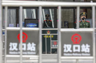 Chinese paramilitary police stand guard outside the closed Hankou Railway Station in Wuhan in central China's Hubei Province, Thursday, Jan. 23, 2020. China closed off a city of more than 11 million people Thursday in an unprecedented effort to try to contain a deadly new viral illness that has sickened hundreds and spread to other cities and countries amid the Lunar New Year travel rush. (Chinatopix via AP)