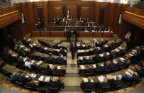 In this Tuesday, July 16, 2019 photo, Lebanese lawmakers and ministers meet at the parliament building during the opening session on the draft 2019 state budget, in Beirut, Lebanon, in Beirut, Lebanon. As the economic crisis deepens in Lebanon, so has the public’s distrust in the ability of the old political class, widely viewed as corrupt and steeped in personal rivalries, to tackle major reform. Many fear a Greek-style bankruptcy, without the European Union to fall back on, and with a potentially more violent social unrest in the small country wedged between war-torn Syria and Israel. (AP Photo/Hussein Malla)