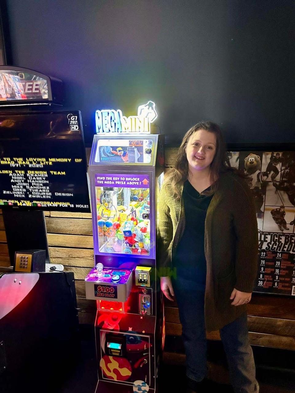 Sarah Wade, 16, places a Mega Mini claw machine at Field House Social at 2525 University Commons Way on Jan. 23, 2024.