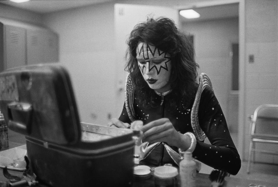 Frehley, who was known for his infectious hyena laugh, attends to his make-up backstage at Cobo Hall in Detroit during the concert recording of Alive! on May 16, 1975. (Photo by Fin Costello/Redferns)