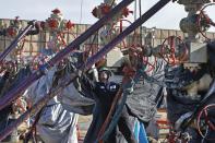 In this March 25, 2014 photo, a worker adjusts pipes during a hydraulic fracturing operation at an Encana Corp. well pad near Mead, Colo. The first experimental use of hydraulic fracturing was in 1947, and more than 1 million U.S. oil and gas wells have been fracked since, according to the American Petroleum Institute. The National Petroleum Council estimates that up to 80 percent of natural gas wells drilled in the next decade will require hydraulic fracturing. (AP Photo/Brennan Linsley)