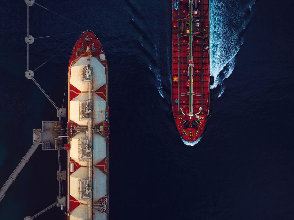 High angle view of a crude oil tanker passing by a moored LNG floating storage tanker.