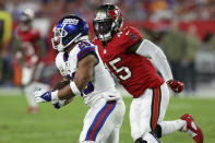 New York Giants running back Saquon Barkley (26) turns the corner on Tampa Bay Buccaneers inside linebacker Devin White (45) during the first half of an NFL football game Monday, Nov. 22, 2021, in Tampa, Fla. (AP Photo/Mark LoMoglio)